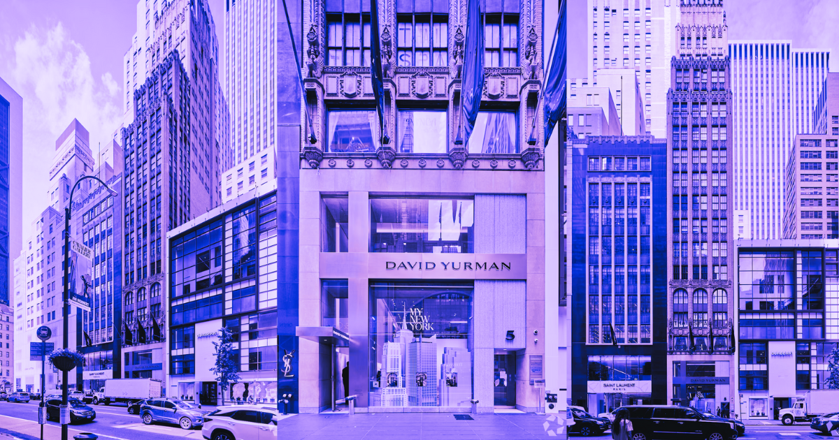 City street with diverse architecture, featuring David Yurman store and parked cars under a purple hue for real estate article.