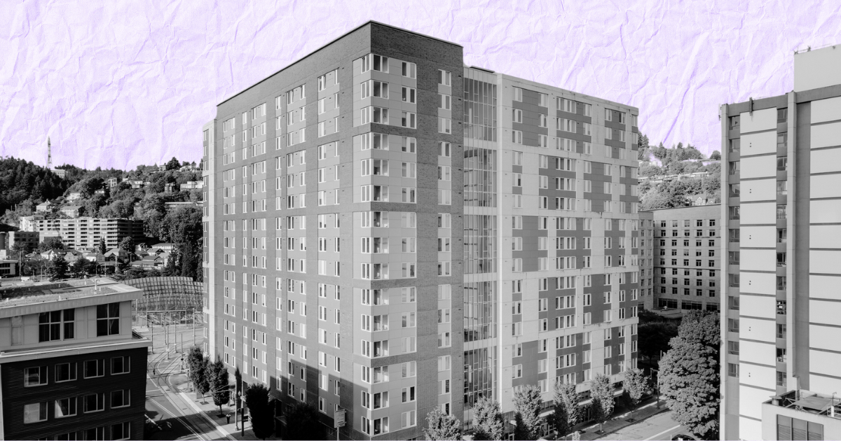 Black and white photo of a tall apartment building with windows, against a light purple sky. For an article on Blackstone's sale.