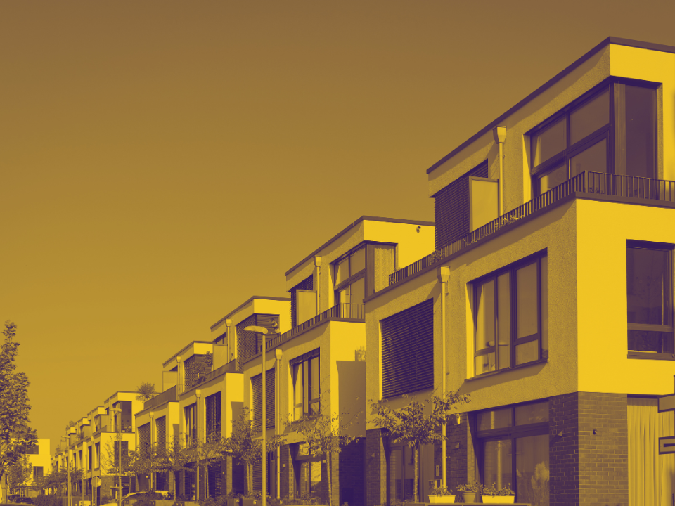 Sepia-toned image of modern, two-story homes with large windows under a clear sky, for an article on student housing trends.