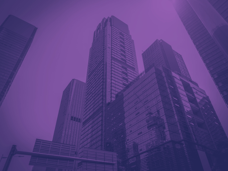 Cityscape with modern skyscrapers under a purple sky, used for a real estate website article titled "Fannie Mae.