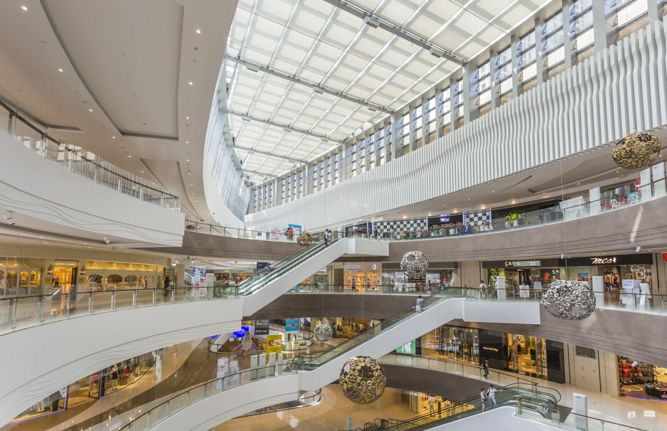 Mall traffic dipped in June after a spring surge, but indoor malls and open-air centers show signs of ongoing recovery.
