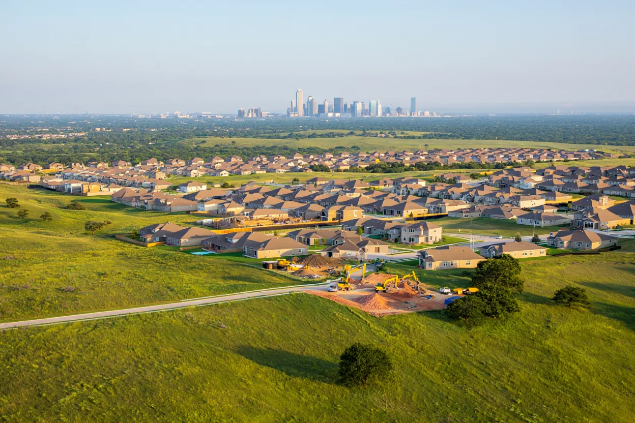 Dallas-Fort Worth growth remains strong, driving housing and commercial development while a slowdown in immigration tempers momentum.