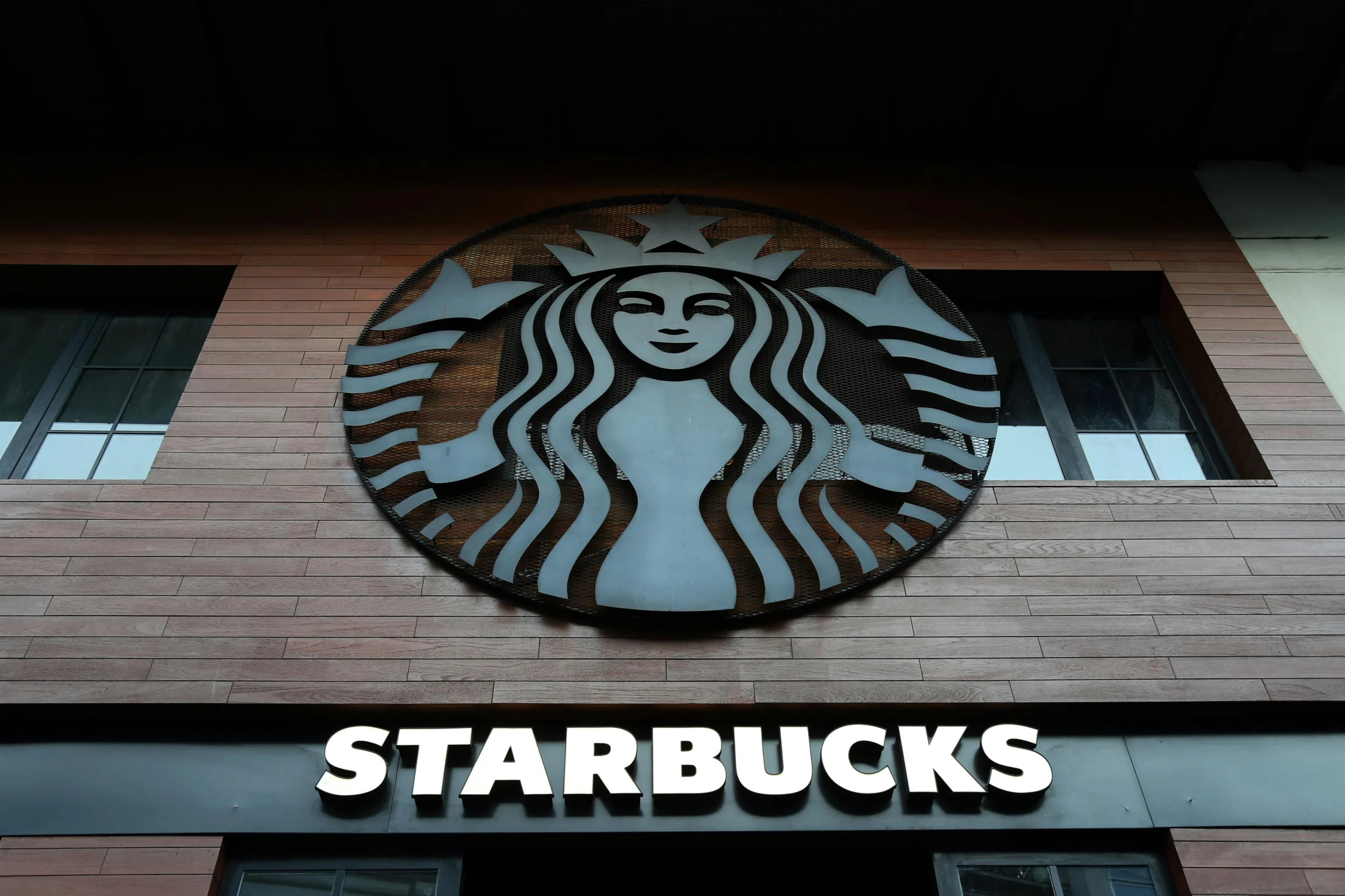 Starbucks will close four US regional offices and cut 300 jobs as it restructures its office footprint around growth hubs.